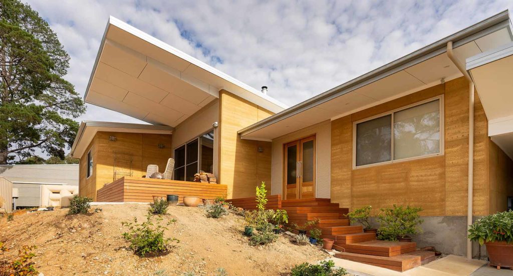 External facade of a sustainable split-level rammed earth home